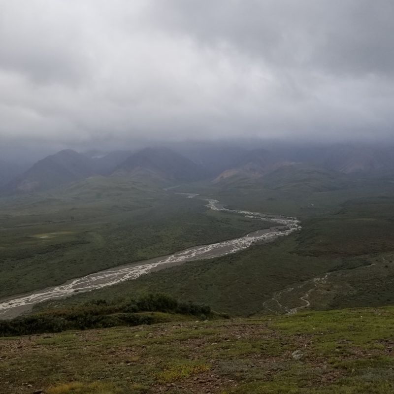 river running through a valley in alaska